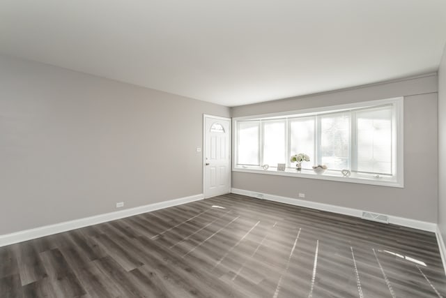 unfurnished room featuring dark hardwood / wood-style floors