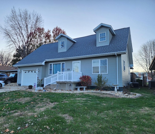 cape cod-style house featuring a garage, cooling unit, and a front lawn