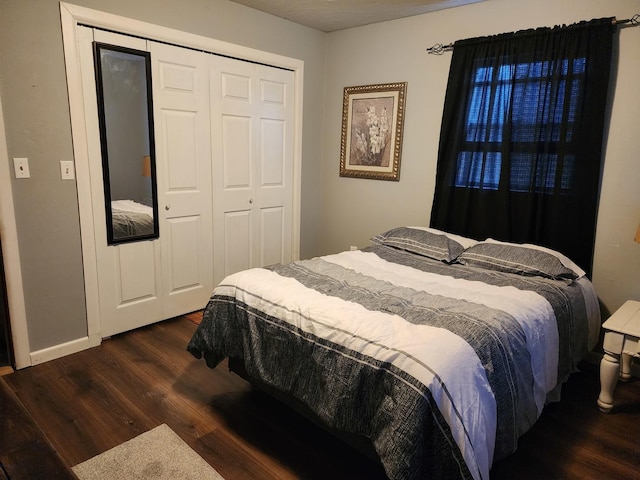 bedroom featuring dark wood-type flooring and a closet