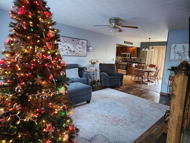 living room featuring dark hardwood / wood-style floors and ceiling fan