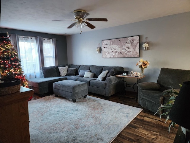 living room with dark wood-type flooring and ceiling fan