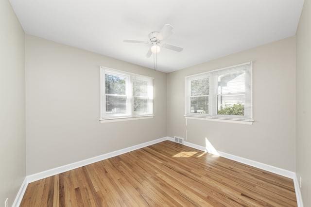 empty room with light wood-type flooring and ceiling fan