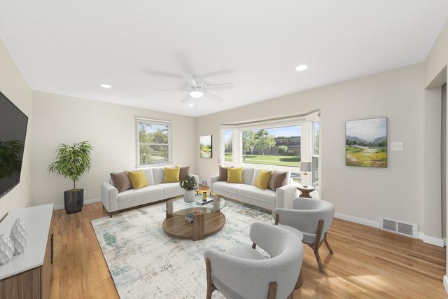 living room with ceiling fan and light hardwood / wood-style floors