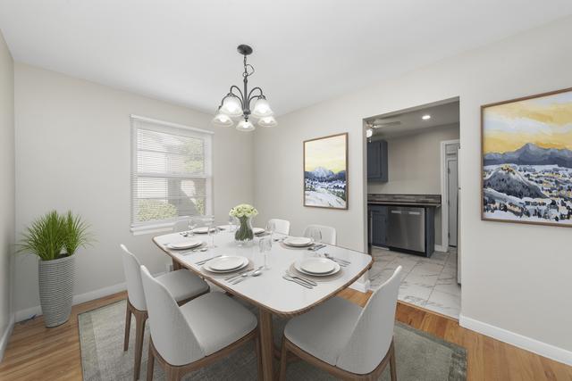 dining space with light wood-type flooring and a chandelier