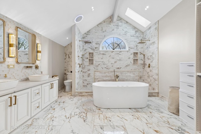 full bathroom featuring vanity, toilet, tile walls, and vaulted ceiling with skylight