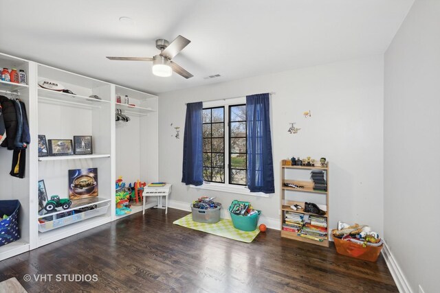 playroom featuring ceiling fan and dark hardwood / wood-style flooring