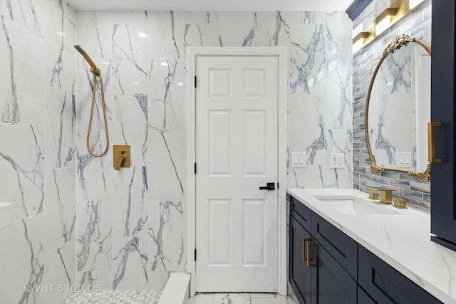 bathroom featuring tiled shower, vanity, backsplash, and tile walls