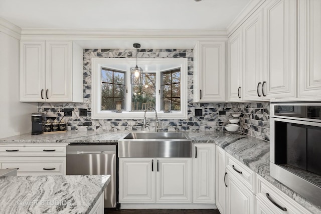 kitchen with white cabinetry, sink, hanging light fixtures, and stainless steel appliances