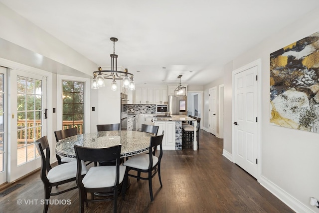 dining room with dark hardwood / wood-style flooring