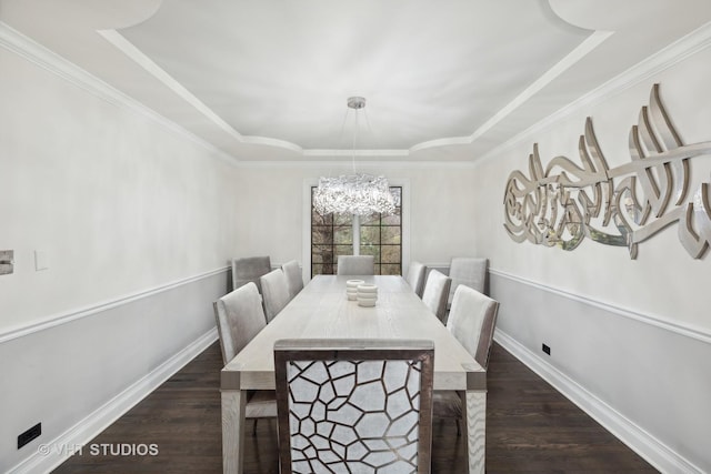 dining area with a tray ceiling, crown molding, dark hardwood / wood-style flooring, and an inviting chandelier