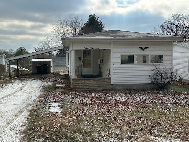 view of front of home with a storage shed