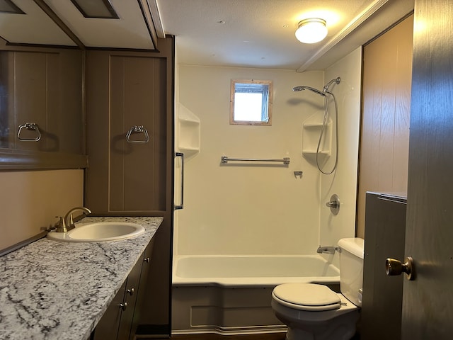 full bathroom with shower / bathing tub combination, vanity, a textured ceiling, and toilet