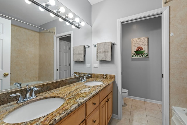 bathroom with tile patterned flooring, vanity, and toilet