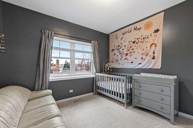 bedroom with light carpet and a nursery area