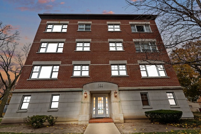 view of outdoor building at dusk