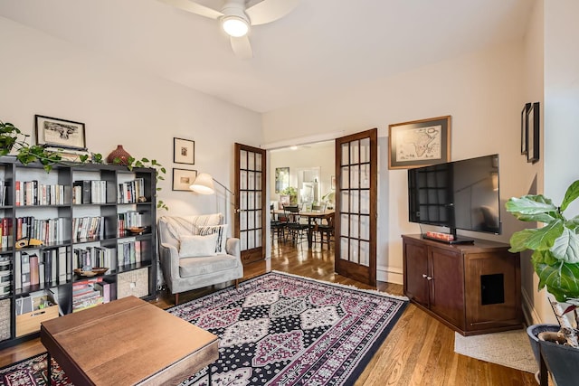 sitting room with light hardwood / wood-style flooring, french doors, and ceiling fan