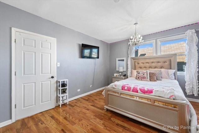 bedroom with a chandelier and hardwood / wood-style flooring