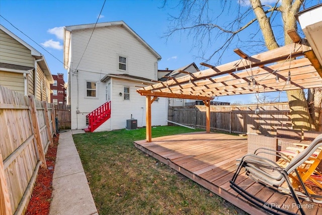 back of property with a pergola, a yard, central AC unit, and a deck