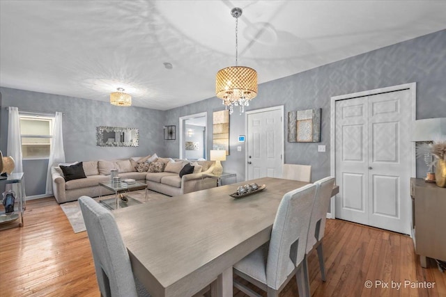 dining area featuring hardwood / wood-style floors and a notable chandelier