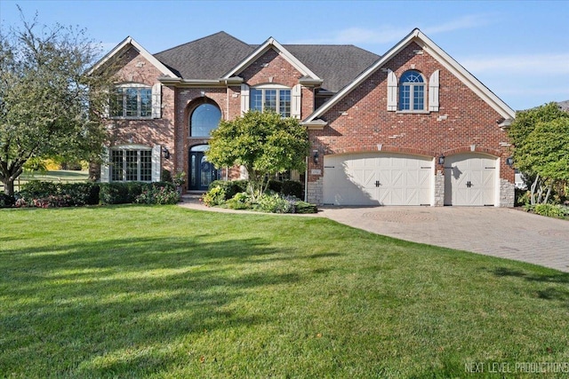 view of property with a garage and a front yard