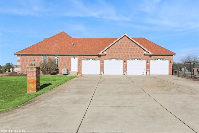 ranch-style home with central AC, a garage, and a front lawn