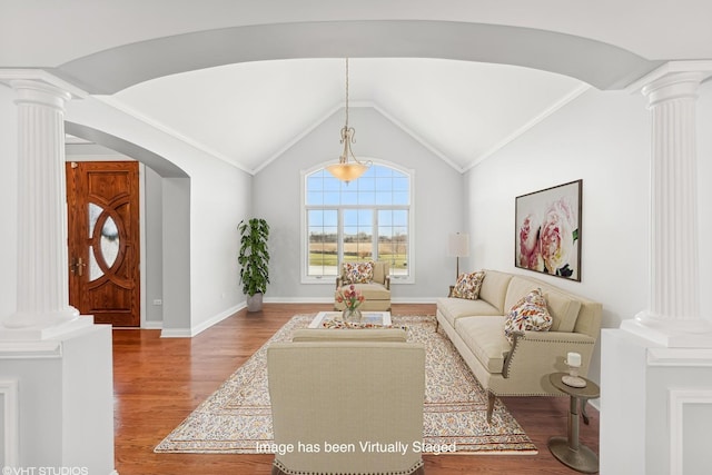 living room featuring hardwood / wood-style flooring, decorative columns, and lofted ceiling