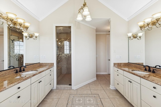 bathroom with tile patterned flooring, vanity, vaulted ceiling, and ornamental molding