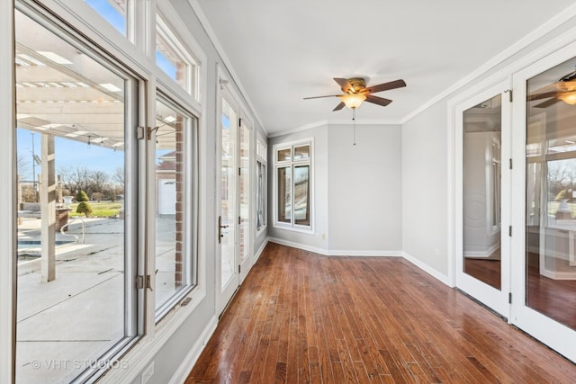 unfurnished sunroom with ceiling fan and french doors