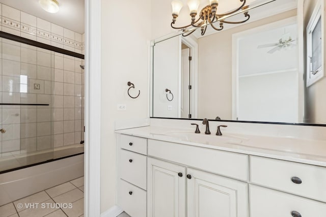 bathroom with tile patterned flooring, ceiling fan with notable chandelier, bath / shower combo with glass door, and vanity