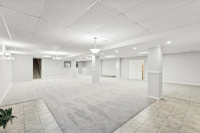 basement with light carpet and a drop ceiling