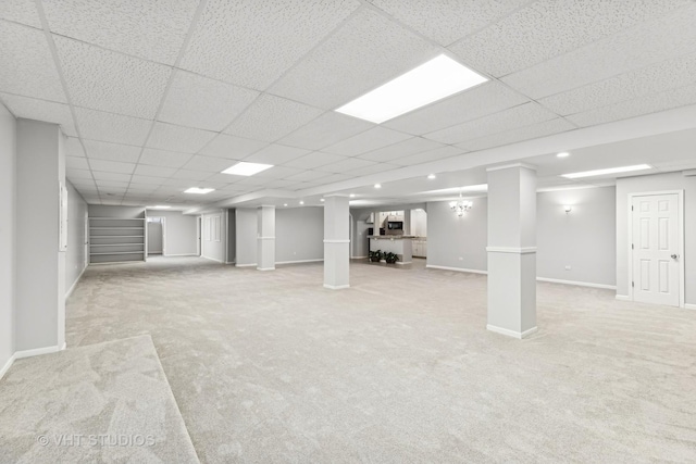 basement featuring carpet flooring and a drop ceiling