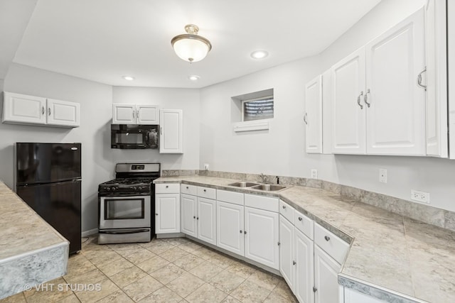 kitchen featuring sink, white cabinetry, and black appliances