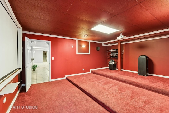 carpeted cinema room featuring a drop ceiling