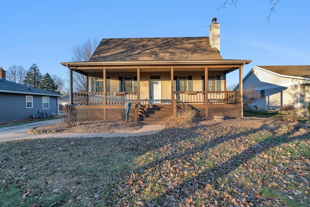 country-style home with central AC unit and covered porch