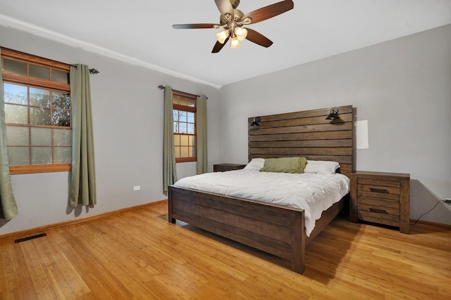 bedroom featuring light hardwood / wood-style floors and ceiling fan