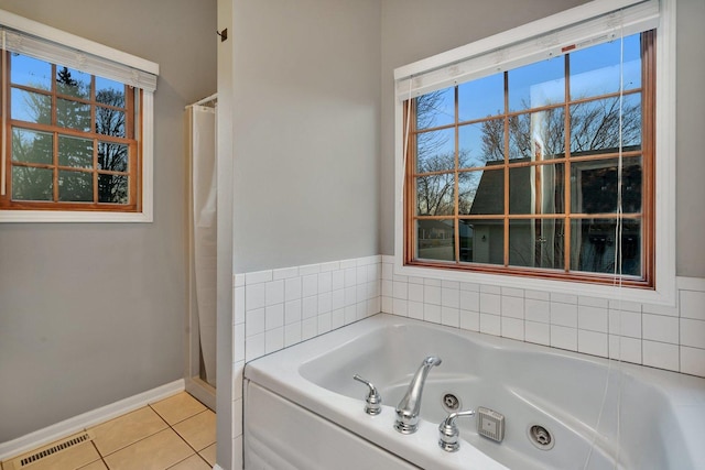 bathroom featuring tile patterned flooring and separate shower and tub