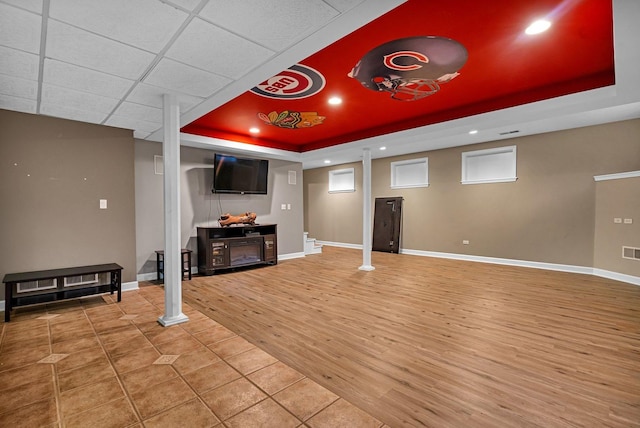 interior space with a paneled ceiling and wood-type flooring