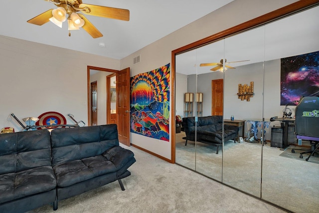 carpeted living room featuring ceiling fan