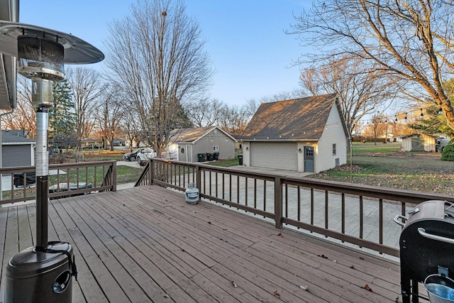 wooden terrace with an outdoor structure and grilling area