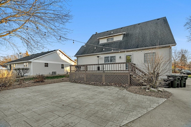 rear view of property featuring central air condition unit, a patio area, and a wooden deck