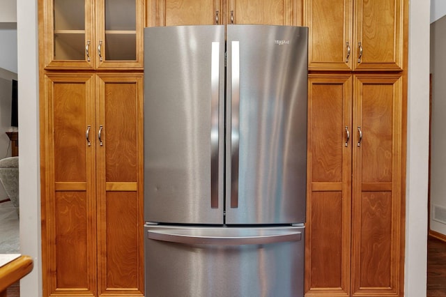 kitchen with stainless steel fridge and hardwood / wood-style floors