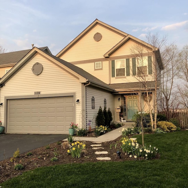 front facade featuring a garage and a front yard