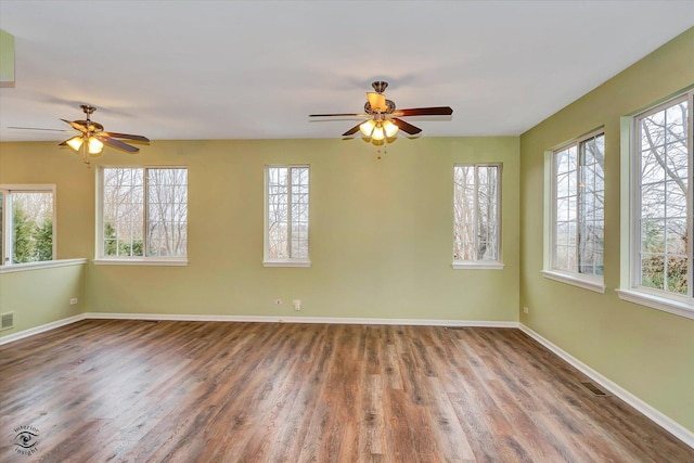 spare room with ceiling fan and wood-type flooring