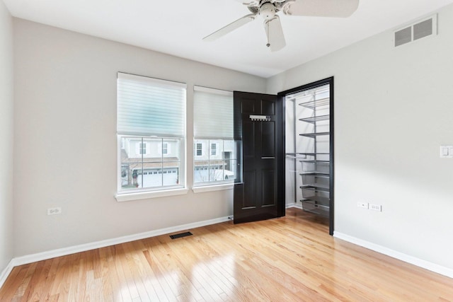 empty room featuring ceiling fan and light hardwood / wood-style flooring