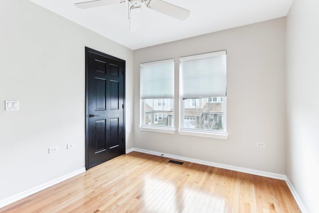 spare room featuring ceiling fan and light hardwood / wood-style floors