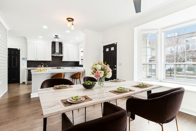 dining space featuring crown molding and dark hardwood / wood-style flooring