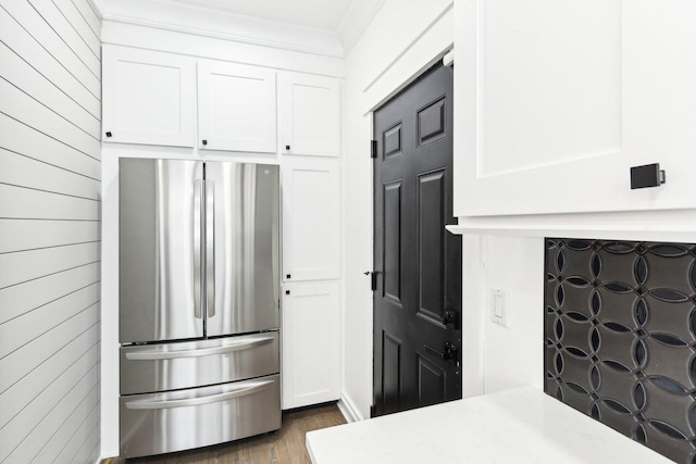 kitchen with white cabinets, dark wood-type flooring, and stainless steel refrigerator