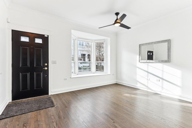 foyer entrance featuring wood-type flooring, ceiling fan, and crown molding