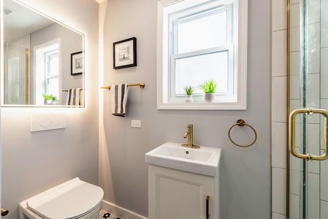 bathroom featuring vanity, toilet, and a shower with door