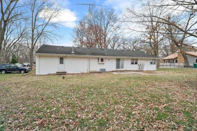 back of house featuring a yard and central air condition unit